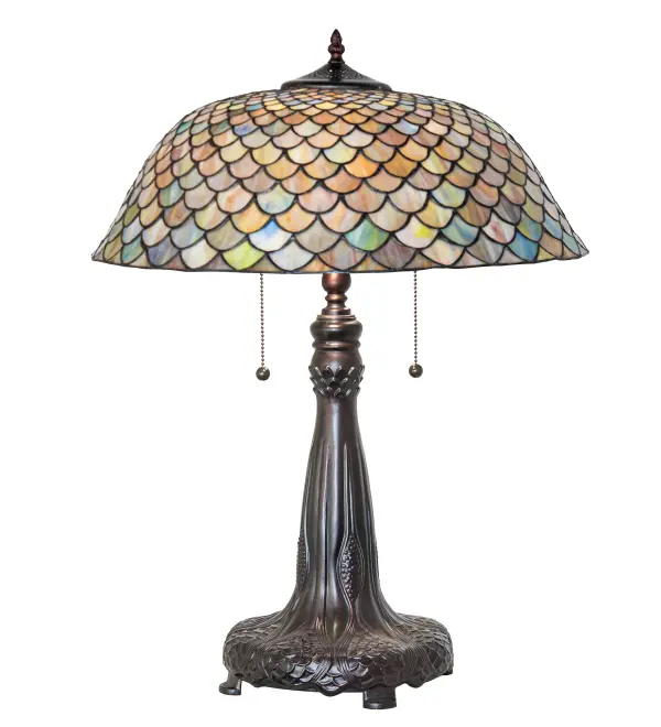 A Louis Comfort Tiffany studio classic... The renowned Fishscale design features a variegated Tortoiseshell of Emerald; Sapphire; Mauve; and Beige colored art glass; evoking a unique dimensional and textured look in a rainbow of brilliant hues. This exquisite art glass shade is created using the famous Meyda Tiffany copperfoil construction process and complemented with an elegant cast metal base featuring a Mahogany Bronze finish. The lamp design was inspired by Rainbow Trout and other colorful fish found in Northwest Montana; Eastern Idaho; and Baja; California. The lamp is perfect for illuminating picture windows; occasional tables; office desks; and other spaces. The Tiffany Fishscale Table Lamp is included in our American-designed; handcrafted Tiffany Reproduction Lighting Collection. UL and cUL listed for dry locations. Each shade is a unique work of art with color variations based on natural ingredients inherent in the glass.