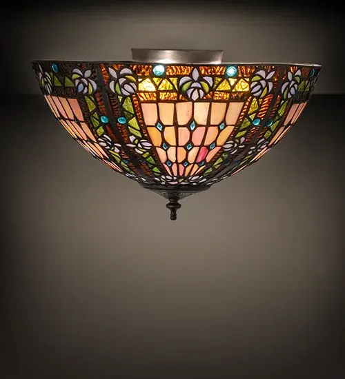 A Meyda Tiffany original... This Fleur-de-lis ceiling fixture is an elegant design featuring stylized three-petal Amber colored Lilies with Blue glass jewels among Amber Granite Glass and Beige Iridescent glass. The stained glass shade is reminiscent of European castles and cathedral glass and is handcrafted utilizing the famous Meyda Tiffany copperfoil construction process. The Fleur-de-lis Flushmount is included in our American-designed; handcrafted Fleur-de-lis Collection. UL and cUL listed for dry and damp locations.