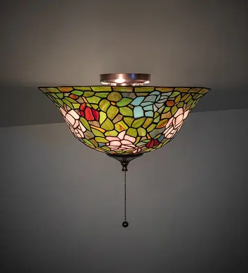 The most beloved of all flowers; the rose; is beautifully represented in this Meyda reproduction of a Tiffany Studio classic. Petal Pink; Romantic Red and Plum Passion art glass roses ramble on a maze of Garden Green leaves. The delicate domed stained glass shade is paired with a graceful; hand finished Mahogany Bronze flushmount fixture.