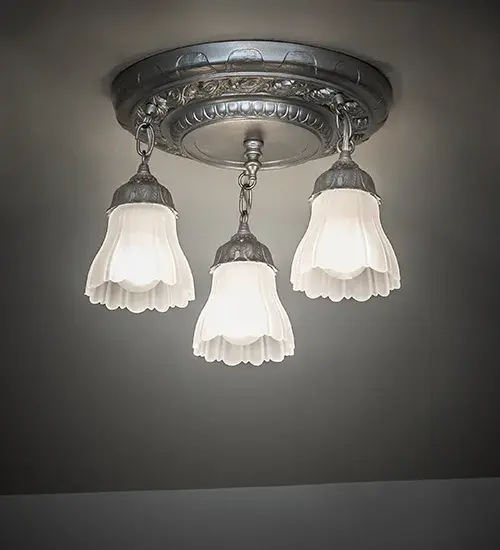 This elegant ceiling fixture features a decorative style adorned with floral accents and finished in Light Sandstone. Three White Victorian Ruffle shades are offered in this exquisite fixture. The Victorian Ruffle Semi-Flush Mount is included in our American-designed; handcrafted Victorian Hardware Collection and is UL listed for dry and damp locations.