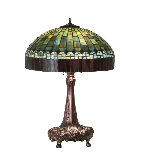 In the early 20th century; Tiffany Studios used artful mastery to develop the look of woven fabric with a fringed skirt out of glass. Meyda Tiffany is able to configure this timeless reproduction into a stunning table lamp. The shade features Multi-hued Plum fringe with dome brickwork intertwined with Emerald; Cobalt; Heather; Xanadu; Azure and Saffron art glass. The art glass shade is created using the famous Meyda Tiffany copperfoil construction process and enhanced with a table base finished in Mahogany Bronze. UL and cUL listed for dry locations.