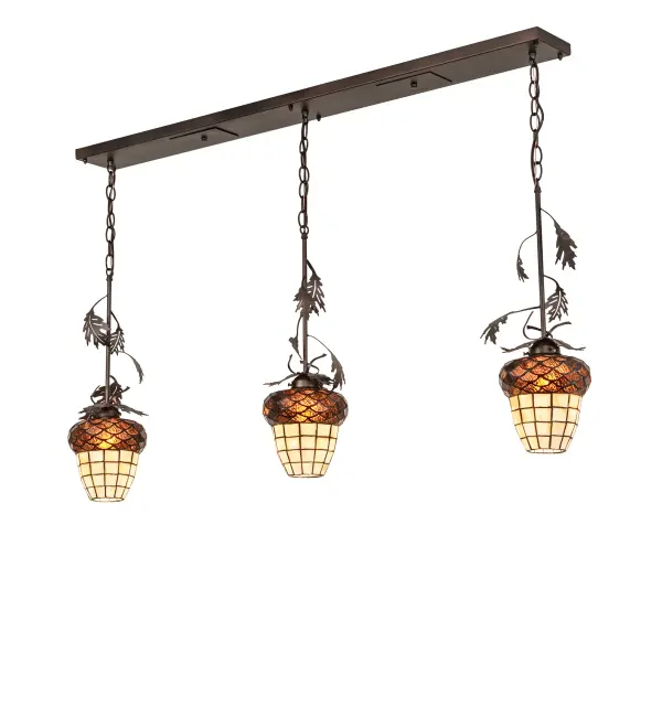 Invite the splendor of Mother Nature in all of its natural beauty into your home. This exquisite; intricate ceiling pendant features three Beige Art Glass Acorn shaped Shades crowned with Bark Brown art glass. Scores of Art Glass pieces are individually hand cut and hand set using the famous Meyda Tiffany copperfoil process. The shades are complemented by Oak Leaf accents and hardware featured in a Mahogany Bronze finish. The fixture is ideal for illuminating bars; islands; and tables in fine homes from Joliet; Illinois; to Kansas City; Kansas; to Sunnyvale; California. The Oak Leaf & Acorn 3 Light Oblong Island Pendant is featured in our American-made; American-designed; handcrafted Nature Inspired Lighting Collection; which is manufactured in Yorkville; New York. The fixture is UL and cUL listed for dry and damp locations. This fixture is manufactured in Yorkville; New York. Upstate New York's adventurous playland; known as the Adirondack Mountains; with its many breathtaking forests; lakes; and rivers; is the spiritual birthplace of Meyda and inspires our rustic-themed art glass collections.