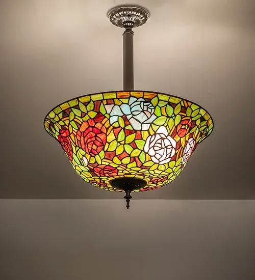 The most beloved of all floral beauties. The Rosebush Inverted Pendant is beautifully represented in this stunning reproduction of a Tiffany Studio Classic. Petal Pink; Romantic Red; and Beautiful Blue art glass Roses ramble on a maze of Garden Green leaves. The shade is created using the famous Meyda Tiffany copperfoil construction and enhanced with a Mahogany Bronze finish. The ceiling pendant is ideal for use above dining tables and entryways in residential and hospitality settings; from Baltimore; Maryland; to Louisville; Kentucky; to Oklahoma City; Oklahoma. The American-designed; handcrafted Tiffany Rosebush Pendant is featured in our Tiffany Reproduction Collection. UL and cUL listed for dry and damp locations. Each shade is a unique work of art with color variations based on natural ingredients inherent in the glass.