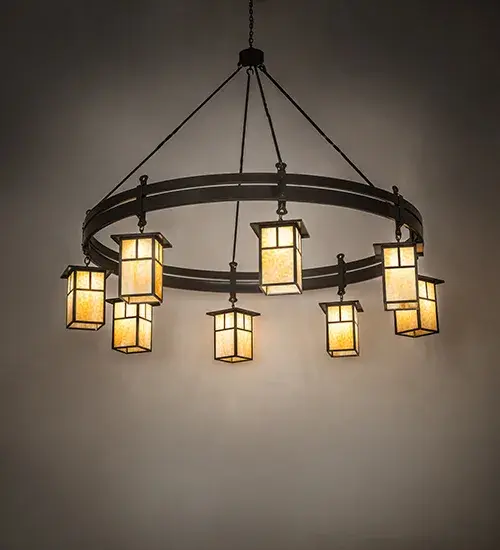 Integrating an elegant style with a classic; distinguished look. This chandelier is custom-crafted; featuring eight Beige Art Glass shades with Beartooth-like metal accents. The fixture is enhanced with a rugged curved frame crafted in a Timeless Bronze finish. Install this chandelier to illuminate dining areas and entryways in residential; commercial; and hospitality locations. The overall height ranges from 73 to 151 inches; as the chain length can be easily adjusted on location to meet your lighting requirements. The Beartooth T Mission Chandelier is featured in our American-made; American-designed; handcrafted Rustic Lighting Collection and is manufactured in Yorkville; New York. UL and cUL listed for dry and damp locations. This fixture was sold to Furniture Showcase in Oelwein; Iowa; and featured in Jamison-Schmitz Funeral Home and Crematory; which is also located in Oelwein.