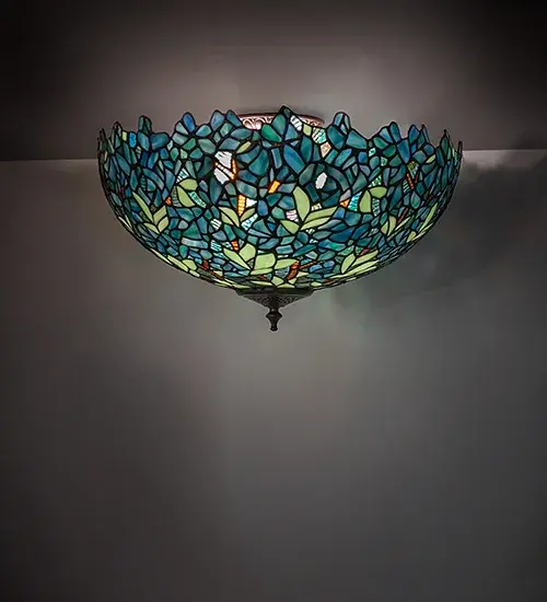 Capture the tranquility of a garden stroll under darkening skies past the deepening blooms and climbing vines of Wisteria shrubbery.. This gorgeous ceiling fixture is created with a Blue; Blue/Green; and Green stained glass shade using the famous Meyda Tiffany copperfoil construction technique. The inverted ceiling fixture is ideal for placement in dining areas and corridors in homes; restaurants; and hotels. The Nightfall Wisteria Flushmount is featured in our American-designed; handcrafted Stained Glass Lighting Collection. The fixture is UL and cUL listed for dry and damp locations. Each shade is a unique work of art with color variations based on natural ingredients inherent in the glass.