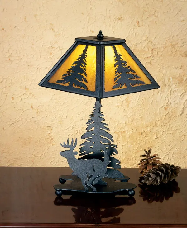 A pine tree accents a linear square shade that sits above a leaping Deer and pine tree lamp base. The accent lamp is finished in Black; has Honey art glass panels and is handcrafted in the USA by Meyda artisans.