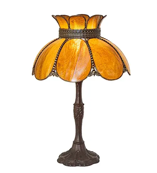 Embrace the timeless look of this classic art glass lighting design. Annabelle features a Hand-Bent Honey Granite Art Glass Shade with Brass filigree and a decorative table base offered in a Highlighted Craftsman Brown finish to reveal an eye-catching dimensional look. The table lamp is perfect as an accent piece in a picture window and on desks and credenzas. It turns on and off with two traditional pull chains. The Anabelle Table Lamp is part of our American-made; American-designed; handcrafted Quality Bent Glass Lighting Collection and is manufactured in Yorkville; New York. It is UL and cUL listed for dry locations. Our Quality Bent Glass division has been in the making for over 100 years and continues to create timeless masterpieces using original tools and techniques from the days when we supplied Louis Comfort Tiffany Studios. Quality Bent Glass originally revolutionized the manufacturing process for high-temperature glass formation by custom-building production capacity; glass-forming ovens; and kilns. We are one of the few remaining manufacturers of bent glass lighting; and we take pride in this rich heritage and expertise. - alternate view