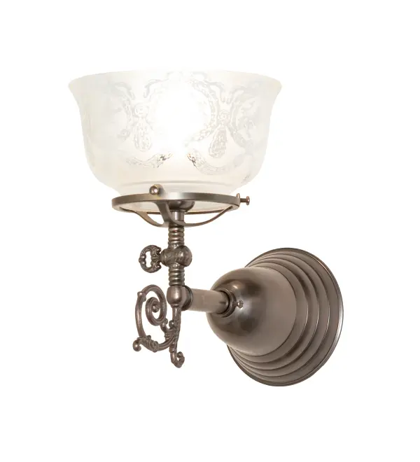 Step back in time with an elegant Brass wall sconce featuring a traditional glass shade, fit, and finish. Reminiscent of lighting fixtures from the early 1900s, the Clear Textured Revival Glass shade boasts an authentic historic look that complements any room or space. Weathered Antique Brass finished hardware and decorative accents make this piece a timeless treasure. This stunning wall fixture is perfect for placement in corridors and dining areas in residential and hospitality settings. The Revival Gas & Electric Wall Sconce is included in our American-designed, handmade Revival Lighting Collection. UL and cUL listed for dry and damp locations. Collection: Revival Finish: Weathered Antique Brass Glass: Clear & Frosted Glass Width: 7.00" Height: 10.00" Length: 11.00" Weight: 3.00 lb Number of Bulbs: 1 Maximum Wattage: 60.00 W Bulb Type: A15 Bulb Base: E26 Material: Brass Country of Origin: USA Safety Rating: Damp
