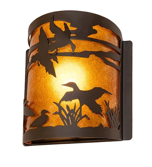 With a swoosh, a flock of Ducks climbs sunward, soaring in flight and stretching out above the marsh reeds against the sun-split sky and up towards the heavens. This charming wall sconce features a stunning Amber Mica shade, which diffuses soft, ambient illumination. The decorative accents, hardware, and frame are available in an Oil Rubbed Bronze finish. To complement this wall fixture, please look at the matching left wall sconce, model 287736. The Ducks in Flight Wall Sconces are included in our American-made, American-designed, handcrafted Wildlife Lighting Collection. The fixtures are manufactured in Yorkville, New York, and are UL and cUL listed for dry and damp locations. Upstate New York's adventurous playland, known as the Adirondack Mountains, with its many breathtaking forests, lakes, and rivers, is the spiritual birthplace of Meyda and inspires our rustic-themed mica collections. Collection: Ducks In Flight Finish: Oil Rubbed Bronze Glass: Amber Mica Width: 8.00" Height: 9.00" Length: 4.50" Weight: 2.50 lb Number of Bulbs: 1 Maximum Wattage: 60.00 W Bulb Type: A19 Bulb Base: E26 Material: Steel Country of Origin: USA Safety Rating: Damp - alternate view
