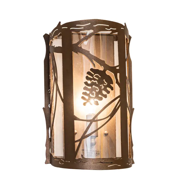 Invite the beauty of nature into your home with a charming ADA-compliant wall fixture featuring metal accents designed as a Pinecone, Pine needles, and branches. Experience the warm beauty of a Crystal Idalight diffuser, enhanced with a Tyler Bronze finish. To make a complete design statement, please take a look at the complementary Right Wall Sconce, model 269302. The Whispering Pines Wall Sconce is featured in our American-made, American-designed, handcrafted Nature Inspired Collection. It is manufactured in Yorkville, New York. It is UL and cUL listed for dry and damp locations. Upstate New York's adventurous playland, known as the Adirondack Mountains, with its many breathtaking forests, lakes, and rivers, is the spiritual birthplace of Meyda and inspires our rustic-themed collections. Collection: Whispering Pines Finish: Tyler Bronze Glass: Crystal Idalight Width: 8.00" Height: 12.00" Length: 4.00" Weight: 4.00 lb Number of Bulbs: 1 Maximum Wattage: 40.00 W Bulb Type: B10 Bulb Base: E12 Material: Steel Country of Origin: USA Safety Rating: Damp