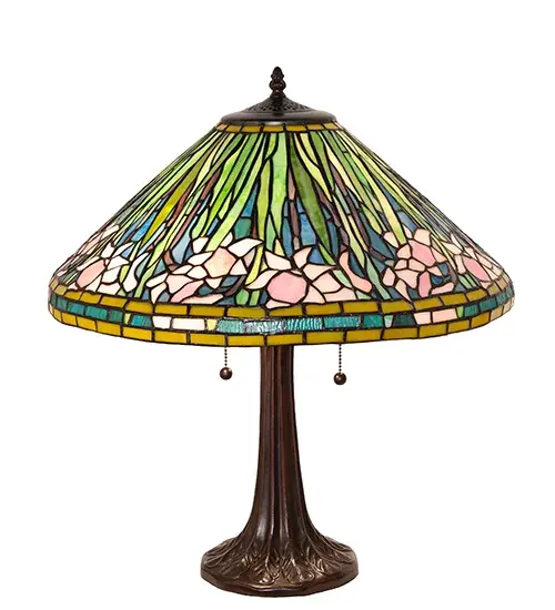 Daffodil is a flower that heralds Spring and is rich in symbolic meaning; a design cultivated and adored by Louis Comfort Tiffany. The magnificently colored stained glass shade; with its range of pinks; ambers; and greens; allows just enough light to make the glass glow and define the various natural forms of these beloved flowers. The shade is created using the famous Meyda Tiffany copperfoil construction and is embraced by an elegant leaf-adorned table base finished by hand in Mahogany Bronze. The Tiffany Daffodill Table Lamp is included in our American-designed; handcrafted Tiffany Reproduction Collection. UL and cUL listed for dry locations. Each shade is a unique work of art with color variations based on natural ingredients inherent in the glass. - alternate view