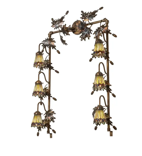 As distinctive as beautiful Peacock fanning feathers in the wild; no two shades will ever be the same. Their individuality can be as remarkably unique as their personality in this six-light pendant. This artistic creation uses art glass background combinations; including Beige; Yellow Pinks; Golden Greens; Ivory; Bluish Whites; Turquoise Blues; Olive; and Spring Greens. The eye of the plumage design reveals Purples; Pastel Blues; Teals; Cobalt; and Ivory; accented with Blue- and Purple- colored jewels. Six exquisite stained-glass shades are crafted using the famous Meyda Tiffany copper-foil construction technique. The fixture is ideal for illuminating vanities in fine baths and is enhanced with two dozen exquisite metal Oak Leaves; Acorns and hardware finished in Dark Burnished Antique Copper. The Tiffany Jeweled Peacock 6 Light Vanity Light is featured in our American-designed; handcrafted Tiffany Reproduction Collection. UL and cUL listed for dry and damp locations. Each shade is a unique work of art; with color variations reflecting the natural ingredients inherent in the glass.