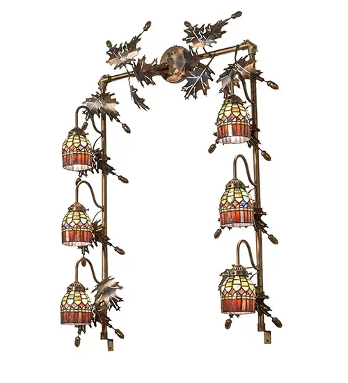 Elegant and distinctive; this Tiffany Candice vanity light features six stained glass shades with an Amber Plum glass fringe surrounding the domed brickwork of Emerald; Cobalt; and Ruby with Purple diamond-shaped accents for the look of woven fabric. The stunning lighting fixture is truly a work of art; with sculpted metal Oak leaves adorning the Dark Burnished Antique Copper finished frame. The fixture is ideal for placement in fine powder rooms in residences and hospitality spaces. The six stained glass shades are created using the famous Meyda copper foil construction. The fixture is UL and cUL listed for dry and damp locations. The Tiffany Candice 6 Light Vanity Light is included in our American-designed; handcrafted Tiffany Reproduction Lighting Collection. Each shade offers color variations based on natural ingredients inherent in the glass. - alternate view