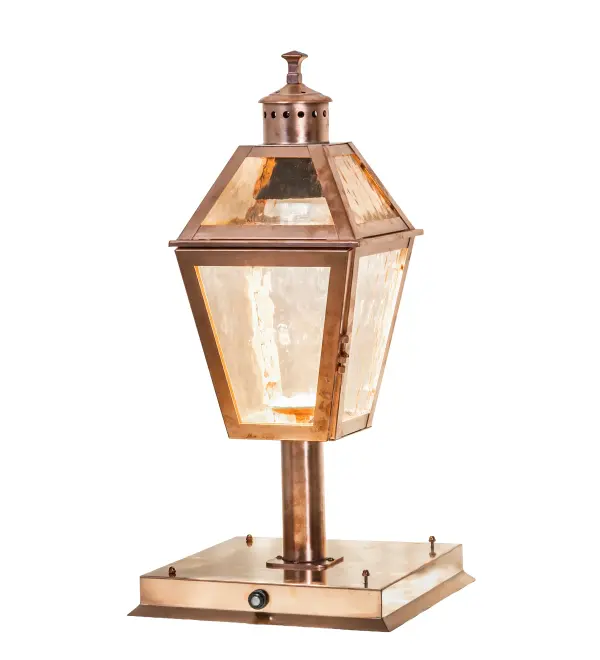 A timeless design combines classic styling and hand-craftsmanship to create the regal Corrina Lantern Pier Mount for fine exteriors. The Rose Gold Art Glass Lens reveals a lamp that provides beautiful ambient lighting from within the lantern. The frame; decorative accents; and hardware are finished in Raw Copper. The fixture is ideal for placement on posts and columns on decks and patios in colonial and craftsman-style homes. The fixture is designed with a door that opens for cleaning and maintenance; as well as a photocell sensor that turns on the outdoor light at Dusk and off at Dawn. It is Dark Sky Compliant as the MR16 lamp is directed downward. The Corrina Pier Mount is included in our American- made; American-designed; handcrafted Traditional Lighting Collection. The fixture is manufactured in Yorkville; New York. It is UL and cUL listed for dry; damp; and wet locations.