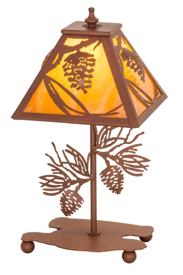 Listen closely. You can almost hear the soft whisper of pine branches as they dance in the wind. Enjoy the beautiful ambiance of the soft light diffused through the Honey art glass shade, and Rust-finished steel base, both which feature stunning pinecone and pine needle motifs. Ideal for accenting various tops of tables and counters, the lamp is handcrafted by skilled artisans in Yorkville, New York at the foothills of the breathtaking Adirondack Mountains. Custom colors, designs and sizes are available, as well as dimmable, energy efficient lighting options such as LED. This lamp is UL and cUL listed for dry locations. Collection: Whispering Pines Finish: Rust Rust Glass: Honey Amber Art Glass Width: 11.00" Height: 15.00" Length: 7.75" Weight: 4.00 lb Extension from Wall: 6.50" Number of Bulbs: 1 Maximum Wattage: 40.00 W Bulb Type: CA7 Bulb Base: E12 Material: Steel Country of Origin: USA Safety Listing: Dry Safety Rating: Dry