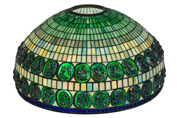 Inspired by the Tiffany Studios masterpiece; this classic reproduction shade combines fine artistry; superior craftsmanship; and beautiful ambient lighting. Originally created for Louis Comfort Tiffany's living room in his famed country residence; Laurelton Hall; on Long Island outside New York City; this unique lighting shade exudes positive elegance. Two stunning; belted bands feature inset borders of oval-shaped Emerald glass Turtleback accents; highlighted against a geometric background of Cream with Sunburst colors. This gorgeous art glass shade is crafted using the renowned Meyda Tiffany copper foil construction technique. It pairs well with a table or floor base and matches beautifully with hardware to create a ceiling pendant or flush mount. The Tiffany Turtleback Double Belted Shade is included in our American-designed; handcrafted Tiffany Reproduction Collection.