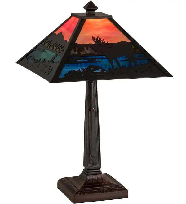 An Moose wanders by a lake in the woods on this nature inspired etched brass lamp shade. The lamp is finished in Mahogany Bronze with Stormy Orange and Blue Green stained art glass panels; and is handcrafted in the USA by Meyda artisans.
