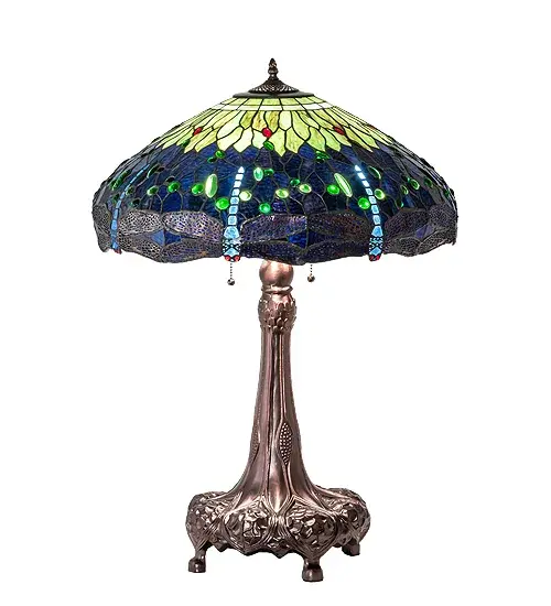 This version of Tiffany Studio's most beloved stained glass dragonfly design, is modeled after the original hanging head dragonfly. Diving dragonflies with glowing Scarlet jeweled eyes and delicate metal filigree wings circle over hand cut and copper foiled pieces of Amber streaked, Pond Green and dusky sky Blue Violet art glass accented with glistening jewels of Sea Green and Amber, representing an early evening sky reflecting on rippling water. The table lamp base is finished in a warm hand applied mahogany bronze. Collection: Tiffany Hanginghead Dragonfly Finish: Mahogany Bronze Glass: Stained Glass Width: 22.00" Height: 32.00" Length: 22.00" Weight: 18.00 lb Number of Bulbs: 3 Maximum Wattage: 60.00 W Bulb Type: A19 Bulb Base: E26 Material: Zinc/Steel Country of Origin: CHINA Safety Listing: Dry Safety Rating: Dry - alternate view