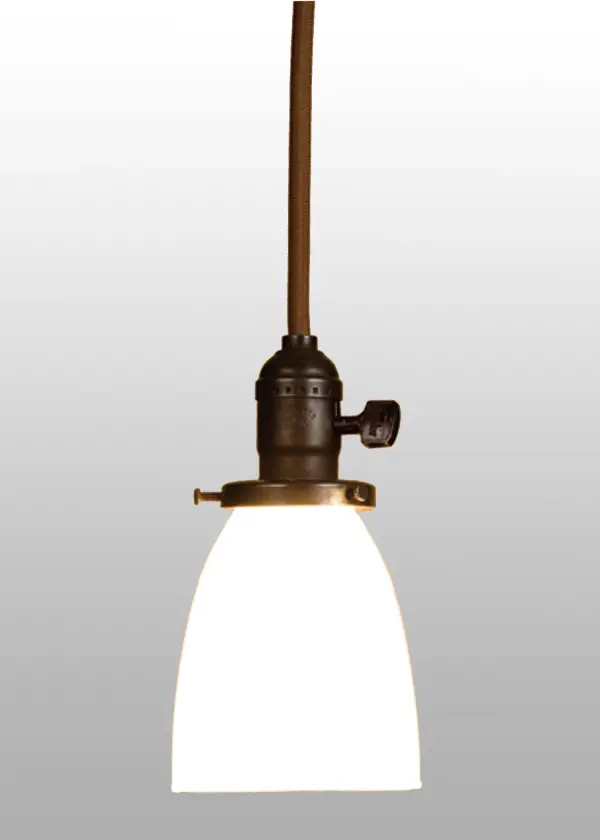 An era of style and elegance is restored with this early electric reproduction Chelsea mini pendant with a goblet shaped White opal glass shade. The handsome cloth covered wire paddle switch fixture is crafted from brass in the USA by Meyda artisans and hand finished in Craftsman Brown with a Brown cord cover.