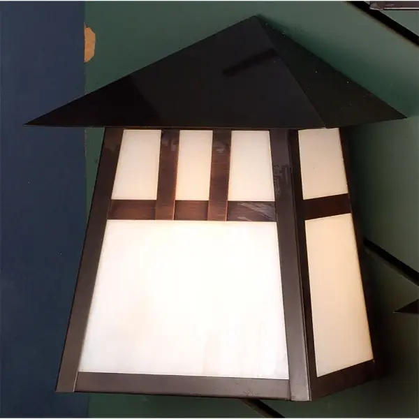 The Double Bar Mission has a pair Arts and Crafts style crossed bars that accent this handsome American Craftsman lantern style wall sconce. The fixture, handcrafted in the USA by Meyda artisans, is finished in Craftsman Brown and has White glass panels. Collection: Stillwater Finish: Craftsman Brown Glass: White Art Glass Width: 9.00" Height: 10.50" Length: 5.50" Weight: 7.00 lb Extension from Wall: 5.50" Number of Bulbs: 1 Maximum Wattage: 60.00 W Bulb Type: A19 Bulb Base: E26 Material: Steel Country of Origin: USA Safety Listing: Wet Safety Rating: Wet