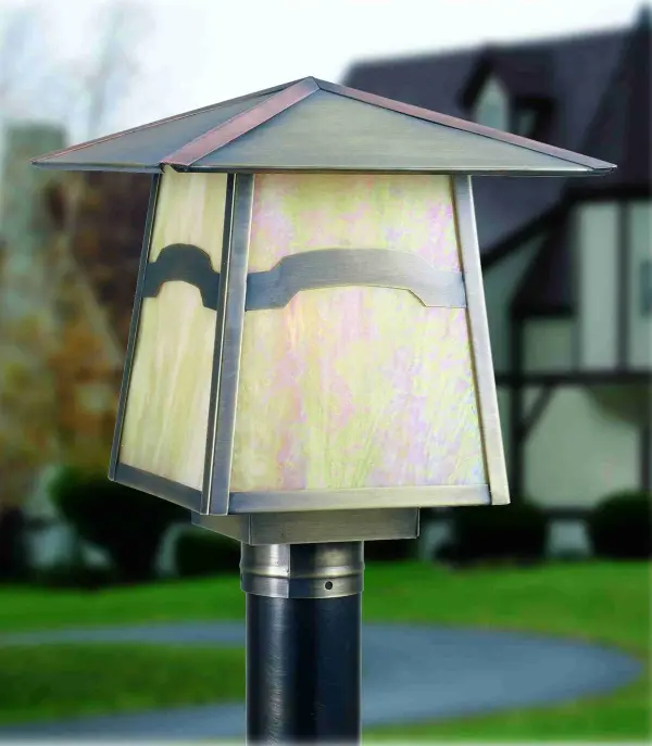 An Arts and Crafts Mountain View recurved bar accents this handsome American Craftsman lantern style post mount. The fixture; handcrafted in the USA by Meyda artisans; has an Antique finish and has Iridized Beige glass panels.
