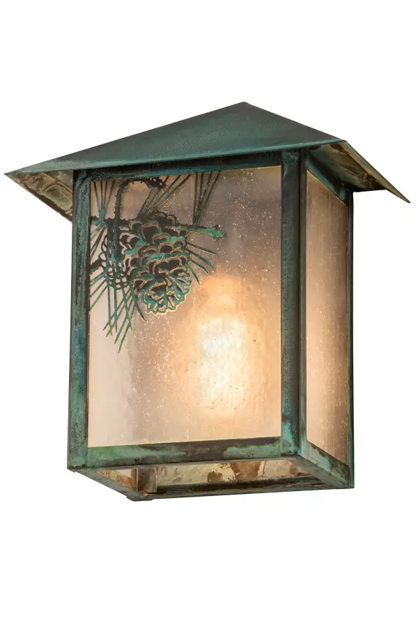 Pine Cone laden branches accent this handsome American Craftsman lantern style wall sconce. The fixture, handcrafted in the USA by Meyda artisans, is finished in Verdigris and has Clear Seedy glass panels. Collection: Seneca Finish: Verdigris Glass: Clear Seeded Glass Width: 9.00" Height: 10.50" Length: 5.50" Weight: 4.00 lb Extension from Wall: 5.50" Number of Bulbs: 1 Maximum Wattage: 60.00 W Bulb Type: A19 Bulb Base: E26 Material: Brass Country of Origin: USA Safety Listing: Wet Safety Rating: Wet