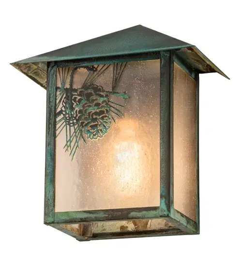 Pine Cone laden branches accent this handsome American Craftsman lantern style wall sconce. The fixture, handcrafted in the USA by Meyda artisans, is finished in Verdigris and has Clear Seedy glass panels. Collection: Seneca Finish: Verdigris Glass: Clear Seeded Glass Width: 9.00" Height: 10.50" Length: 5.50" Weight: 4.00 lb Extension from Wall: 5.50" Number of Bulbs: 1 Maximum Wattage: 60.00 W Bulb Type: A19 Bulb Base: E26 Material: Brass Country of Origin: USA Safety Listing: Wet Safety Rating: Wet - alternate view