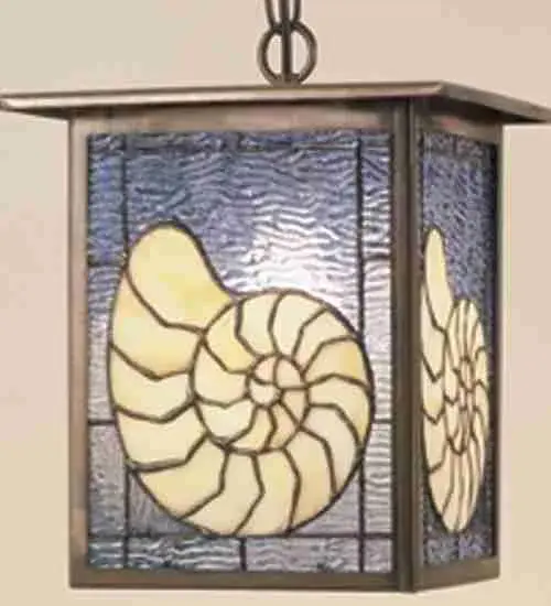 An ocean Nautilus shell is depicted on this sea inspired lantern pendant. The fixture is finished in a Verdi washed Copper, has Beige and Blue transparent textured art glass panels, and is handcrafted in the USA by Meyda artisans. Collection: Seashell Finish: Antique Copper Glass: Stained Glass Panels Width: 9.00" Height: 10.00" Length: 9.00" Number of Bulbs: 1 Maximum Wattage: 60.00 W Bulb Type: A19 Bulb Base: E26 Material: Brass Country of Origin: USA Safety Rating: Dry