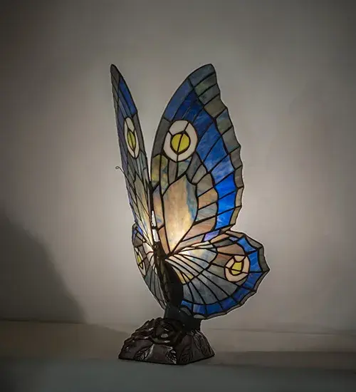 This irresistible Butterfly is hand finished in Mahogany Bronze; and has Grape and Sage colored lighted wings; crafted of copper foil wrapped stained art glass.