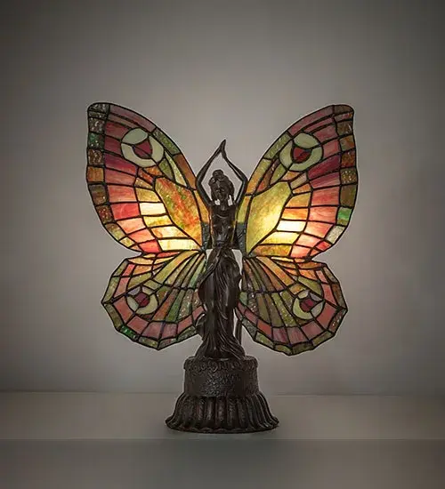 This irresistible Butterfly Lady is hand finished in Mahogany Bronze; and has colorful Plum and Leaf Green lighted wings crafted of copper foil wrapped stained art glass.