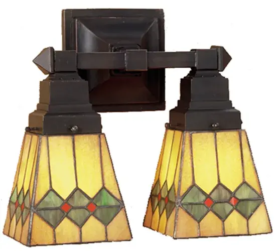 In keeping with the Mission style of translating objects into geometric forms; the Meyda Tiffany design team has taken the martini; complete with olive; and transformed it into this stylish stained glass shade. Olive Green diamonds with Pimento Red accents garnish the Honey Amber shade that is suspended from linear Mission styled two light wall sconce in Mahogany Bronze.