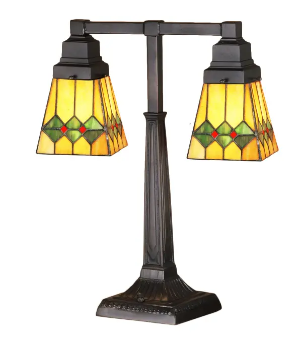 In keeping with the Mission style of translating objects into geometric forms; the Meyda Tiffany design team has taken the martini; complete with olive; and transformed it into this stylish stained glass shade. Olive Green diamonds with Pimento Red accents garnish the Honey Amber shade that is suspended from a linear Mission styled two light desk lamp base in Mahogany Bronze.