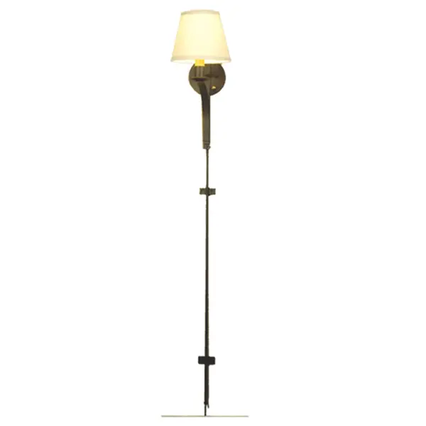 Exquisite styling and luxurious charm are revealed in the minimalist Minaret wall sconce. This elegant sconce embraces an Amber-colored faux candlelight topped with a Beige fabric shade and complemented with a backplate; hardware and a very extensive stem that embraces both the wall and floor; in a Wrought Iron finish.The fixture features quality materials and hand detailed American craftsmanship perfected by years of time honored artistry; passed down from generations of prolific artisans.Custom sizes; styles; colors and dimmable energy efficient lamping options are available.The fixture is UL and cUL listed for damp and dry locations.A matching Minaret Left Wall Sconce (48510) is also available to complete the set; for design continuity.