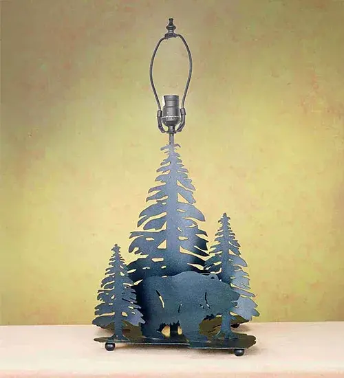 Drawing inspiration from the wildlife and natural beauty in the nearby Adirondack Mountains; this handsome table lamp depicts a majestic Bear silhouette design on its base; which is enhanced with a Textured Black finish. The Grizzly Bear Through the Trees Table Base is featured in our American-made; American-designed; handcrafted Wildlife Lighting Collection. Upstate New York's adventurous playland; known as the Adirondack Mountains; with its many breathtaking forests; lakes; and rivers; is the spiritual birthplace of Meyda and inspires our rustic-themed collections.
