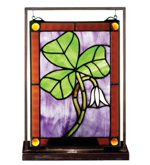 The Luck of the Irish comes to light beautifully with a Green Shamrock and White Lily against Purple art glass; which is bordered in Rootbeer art glass with Amber colored glass jewels. Illuminated from a bulb located behind the glass; the mini tabletop stained glass window is creating using the famous Meyda copperfoil construction process. This mini window is encased in a solid brass channel frame and hangs perfectly in its own brass tabletop display. Custom sizes; designs and colors are available.