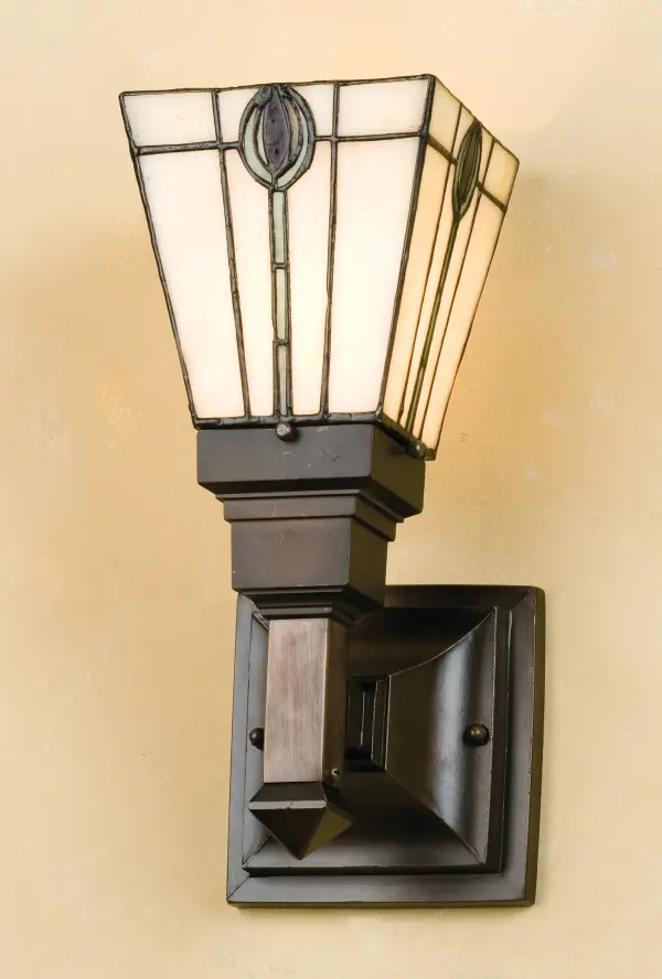 A stylized Spear of Avocado Green and Plum adorn each side of this Beige Glass shade. Mission style hardware in a hand applied Mahogany Bronze finish supports the handsome square shade inspired by the American Arts and Crafts movement. Handcrafted with the copper foil technique developed by Louis Comfort Tiffany, this wall sconce fixture is a true masterpiece. Collection: Spear Finish: Mahogany Bronze Glass: Stained Glass Width: 5.00" Height: 11.50" Length: 7.00" Weight: 5.00 lb Extension from Wall: 7.00" Number of Bulbs: 1 Maximum Wattage: 60.00 W Bulb Type: A19 Bulb Base: E26 Material: Zinc Country of Origin: CHINA Safety Listing: Dry Safety Rating: Damp