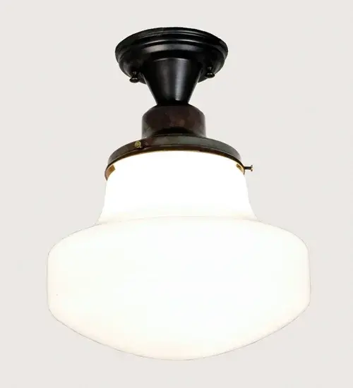 Schoolhouse Glass is a term used for ceiling mounted opal glass fixtures that are commonly used in schools and other public buildings. With the invention of the electric lamp; these bright opal glass shades used as pendants and ceiling fixtures; are economical; decorative and always in style. This Schoolhouse Shade is paired with semi flush hardware; hand finished in Craftsman Brown "