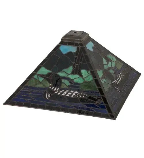 A stunning image of this aquatic bird floating on a lake near the woodlands is captured in Blue Stained Glass against a landscape of various Green colors with a Bark Brown Stained Glass tree to complement the shade's border. This wildlife-inspired shade was created using the famous Meyda copper foil construction process. The shade can be paired with a base to create a table lamp or hardware to build a ceiling fixture. The lighting design is inspired by Loons from the Great Lakes region to the Florida coasts; to Alaska's Aleutian Islands. The Loon Shade is included in our American-designed; handcrafted Wildlife Collection. - alternate view