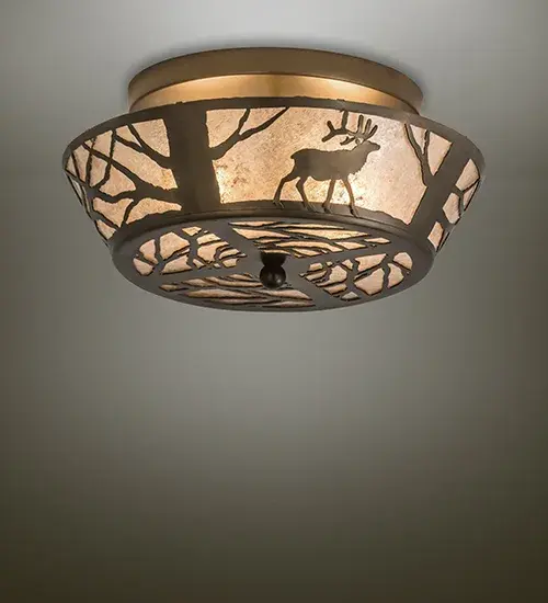 Rustic charm is captured beautifully with a majestic Elk meandering around Pine Trees through the woodlands. A stunning Silver Mica shade featuring an elaborate Pine Tree and Pine Branches motif is enhanced with a matching bottom diffuser. The decorative accents and hardware are featured in an Antique Copper finish. The Elk on the Loose Flushmount is Domestically Produced in our 180;000 square foot manufacturing facility in Yorkville; New York. Customize the shade colors; metal finishes and sizes to meet your desires. UL and cUL listed for dry and damp locations.