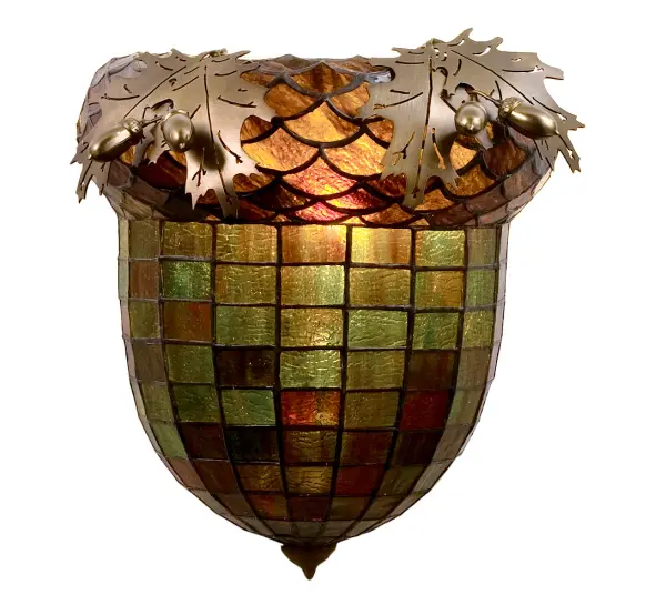 Majestic as the mighty oak is this leaf adorned wall sconce in an antique copper finish. A lighted stained glass acorn, in multi toned Autumn Green with a Bark Brown granite glass crown sprouting oak leaf covered hardware that is hand made in the USA by Meyda Tiffany craftsmen. Collection: Oak Leaf & Acorn Finish: Antique Copper Glass: Stained Glass Width: 12.00" Height: 12.00" Length: 6.00" Weight: 5.00 lb Extension from Wall: 6.00" Number of Bulbs: 1 Maximum Wattage: 60.00 W Bulb Type: A19 Bulb Base: E26 Material: Steel Country of Origin: USA Safety Listing: Damp Safety Rating: Damp