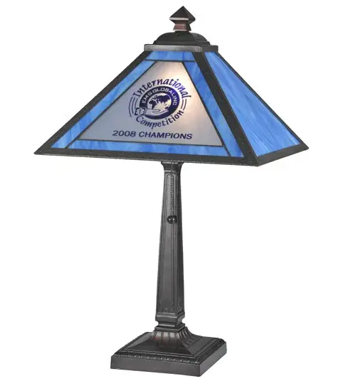 Designed with the EMS GLOBAL INC name and logo and 2008 CHAMPIONS International Competition... The handsome shade features Light Blue art glass; a White glass medallion; and personalized verbiage in Dark Blue. The shade is complemented with a Highlighted Craftsman Brown table base. The Personalized EMS Global Inc Table Lamp is included in our American-made; American-designed; handcrafted Personalized Lighting Collection and manufactured in Yorkville; New York. The lamp is UL- and cUL-listed for dry locations. This art glass shade can be ordered; and we will coordinate the custom logo with you to suit your project. Call for pricing and lead time. - alternate view