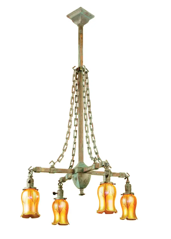 An era of style and grace is restored with this early electric reproduction. The Craftsman chandelier evokes romance and a classic look. It features four Gold Iridescent Favrile style glass shades that are mouth blown into Tulip profiles. The hardware is made from Solid Brass and hand finished in Vintage Copper Verdigris. This Solid Brass fixture can be used in halls and entryways while giving soft light in fine homes and restaurants and other spaces. The Craftsman Favrile Chandelier is part of our American made and American designed hand crafted Favrile Collection built in Yorkville New York. The fixture is UL and cUL listed for dry and damp locations.