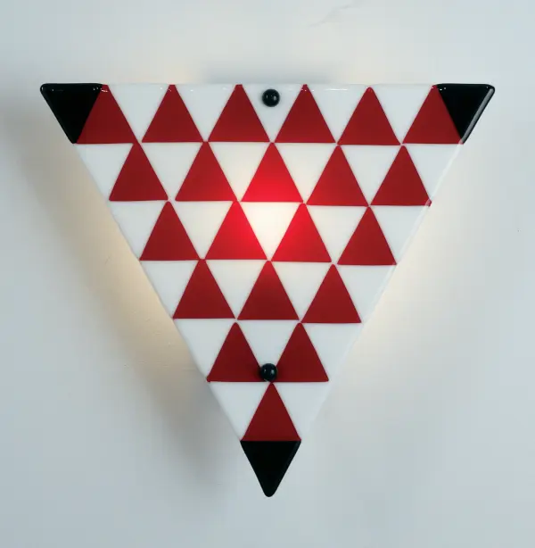 Get your fill of fun and games with the Jester; Metro Fusion ADA compliant wall sconce. Hand cut Black; Red and White glass triangles cascade on a triangular shaped shade. Fused together in a hot kiln; this fun sconce shade is suspended by Nickel finished powder coated hardware. Designed and created by Meyda artists and craftsmen; for a unique; contemporary fixture.