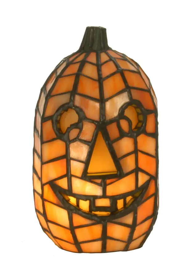 Bring autumn charm and appeal into your home with our uniquely lighted Jack-o-Lantern art glass sculpture. Whimsical yet scary, it is facial expression and curved profile are representative of this autumn icon. Functional as a tabletop accent piece and a lamp, this Jack O'Lantern Accent Lamp is handcrafted using the famous Meyda Tiffany copperfoil construction process.The lamp is ideal as an illuminating accent piece on mantels, credenzas, occasional tables, and other spaces in residential and hospitality settings. Inspired by homes in Salem, Massachusetts, to Sleepy Hollow, New York, to Transylvania, Romania. The Jack O'Lantern Accent Lamp is included in our American-designed, handcrafted Halloween Collection. UL and cUL listed for dry locations. Each lamp is a unique work of art with color variations based on natural ingredients inherent in the glass. Collection: Jack O'Lantern Finish: Antique Copper Glass: Oa Ia Ha Width: 5.00" Height: 8.50" Length: 5.00" Weight: 7.00 lb Number of Bulbs: 1 Maximum Wattage: 15.00 W Bulb Type: B10 Bulb Base: E12 Material: Steel Country of Origin: CHINA Safety Listing: Dry Safety Rating: Dry