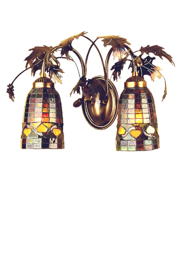 Louis Comfort Tiffany inspired Golden Acorns dance playfully in a ring around these geometric grid patterned elongated shades. The two shades feature Autumn Harvest Honey Wispy Granite Glass, Rust, Olive Green and Bark Brown Glass. Metal Acorns and Oak Leaves are finished in a Warm Antique Copper. The wall luminaire is also perfect as a vanity light in a fine bath. The Tiffany Oak Leaf & Acorn Wall Sconce is featured in our American made, American designed handcrafted Tiffany Nature Inspired Collection. Manufactured in Yorkville, New York. UL and cUL listed for dry and damp locations. Collection: Tiffany Finish: Antique Copper Glass: Stained Glass Notes: Custom Crafted In Yorkville, New York Please Allow 30 Days Width: 17.50" Height: 12.00" Length: 8.50" Weight: 6.00 lb Extension from Wall: 8.50" Number of Bulbs: 2 Maximum Wattage: 60.00 W Bulb Type: A19 Bulb Base: E26 Material: Steel Country of Origin: USA Safety Listing: Dry Safety Rating: Damp