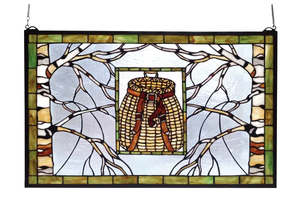 Bare branched Tan and White Birch trees frame a Rattan Beige pack basket with Leather brown straps. The frame and inset frame are bordered in a Rust streaked Meadow Green and the background glass is an icy Clear. The Meyda Tiffany original stained glass window is framed in solid brass and has brass mounting bracket and chains included.