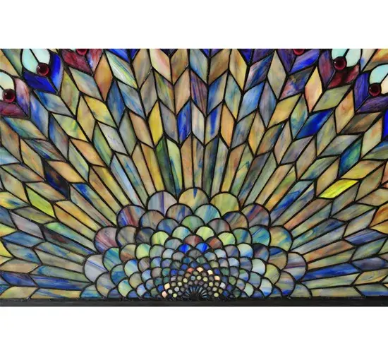 As distinctive as beautiful Peacock fanning feathers in the wild; no two stained glass windows will ever be the same. Their individuality can be as remarkably unique as their personality. This artistic creation utilizes swirling opalescent art glass background combinations; including Beige; Yellow Pinks; Golden Greens; Ivories; Bluish Whites; Turquoise Blues; and Olive and Spring Greens. The eye of the plumage design reveals purple; Pastel Blues; Teals; Cobalt; and ivory; accented with Blue and Purple colored jewels. Individual pieces of glass are hand-cut and wrapped using the famous Meyda Tiffany copperfoil construction technique. To create a dramatic design statement; install this masterpiece to fit the half-moon transom window so the sunlight can show the beauty of the art glass. Perfect for adding beauty and artistry to residential; commercial; and hospitality settings from Savannah; Georgia; to Montgomery; Alabama; to Huntington Beach; California. The Tiffany Jeweled Peacock Stained Glass Window is included in our American-designed; handcrafted Stained Glass Window Collection. UL and cUL listed for dry and damp locations. Each window is a unique work of art with color variations based on natural ingredients inherent in the glass. This window is Custom Made. Call for cost and lead time. - alternate view