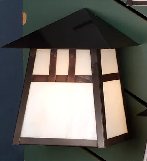 Custom made from Solid Brass. A dramatic Mission-styled straight-line design creates a stunning Craftsman design statement. They are highlighted with a Beige art glass shade and a Craftsman Brown finish. This handsome wall sconce is constructed for interior and exterior applications. It can be mounted to walls while providing beautiful ambient lighting in timber homes, modern farmhouses, and other spaces from Traverse City, Michigan, to Lake Tahoe, Nevada, to Lake Geneva, Wisconsin. The Stillwater Double Bar Mission Wall Sconce is included in our American-made, American-designed, handcrafted Craftsman Signature Series and manufactured in Yorkville, New York. UL and cUL listed for dry, damp, and wet locations. Our Build Your Own Craftsman Signature Series features unlimited combinations of styles, functions, sizes, and finishes. Options include lanterns, pier and post mounts, and deck lights crafted of marine-grade materials like brass and copper with timeless living finishes offered to endure harsh climates. Collection: Stillwater Finish: Craftsman Brown Glass: White Art Glass Width: 12.00" Height: 13.50" Length: 7.50" Extension from Wall: 7.50" Number of Bulbs: 1 Maximum Wattage: 60.00 W Bulb Type: A19 Bulb Base: E26 Country of Origin: USA Safety Listing: Wet Safety Rating: Wet