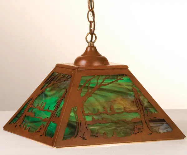 A reflection on simple living in natural surroundings; this Craftsman styled steel pendant features a woodland pond setting as beautiful ambient light shines through Woodsy Green art glass and is complemented with a Rust finish. Inspired by the Arts & Crafts Movement; the fixture is handmade by Meyda artisans at the foothills of the Adirondack Mountains in the USA. Custom sizes; colors and styles are available; as well as dimmable energy efficient lamping options.