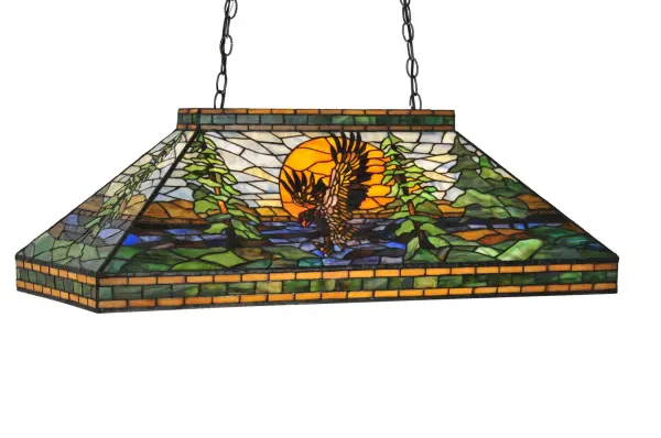 A magnificent nature inspired art glass ceiling pendant. A majestic Bronze Brown Eagle soars against a Blue Sky and Orange Sun in a picturesque woodland setting of Pine Green and Earth Brown framed in Branches and Pinecones. This handsome oblong pendant is enhanced with a Mahogany Bronze finish and handcrafted utilizing the famous Meyda Tiffany copperfoil construction process. Overall height ranges from 23 to 51 inches as the chain can be easily adjusted in the field. Ideal for illuminating billiard tables, kitchen islands and tables, counters and bars. Domestically produced in our 180,000 square foot manufacturing facility in Yorkville, New York. UL and cUL listed for dry and damp locations. Collection: Eagle At Sunset Finish: Mahogany Bronze Glass: Na Xa Oa Va Pbag Ka Width: 18.00" Height: 23.00" Length: 39.00" Weight: 32.00 lb Extension from Wall: 18.00" Number of Bulbs: 3 Maximum Wattage: 60.00 W Bulb Type: A19 Bulb Base: E26 Material: Steel Country of Origin: CHINA Safety Listing: Dry Safety Rating: Damp